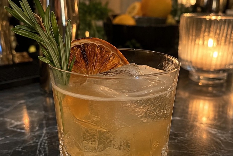 Rocks-glass signature cocktail with dehydrated orange and rosemary at a New Orleans wedding bar